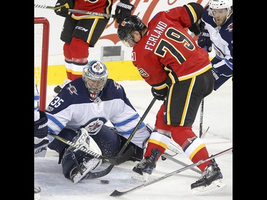 Calgary Flames Micheal Ferland, right, tries to score on Winnipeg Jets  goalie Steve Mason in NHL hockey action at the Scotiabank Saddledome in Calgary on Saturday October 7, 2017. Leah Hennel/Postmedia