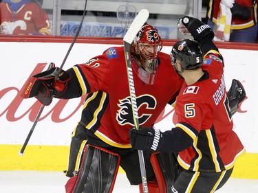 Calgary Flames goalie mike Smith left and Mark Giordano celebrate their 6-3 win over  Winnipeg Jets in NHL hockey action at the Scotiabank Saddledome in Calgary on Saturday October 7, 2017. Leah Hennel/Postmedia