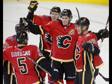 Calgary Flames celebrate their 6-3 win over  Winnipeg Jets in NHL hockey action at the Scotiabank Saddledome in Calgary on Saturday October 7, 2017. Leah Hennel/Postmedia