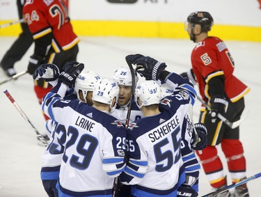 Winnipeg Jets  celebrate a goal on the Calgary Flames in NHL hockey action at the Scotiabank Saddledome in Calgary on Saturday October 7, 2017. Leah Hennel/Postmedia