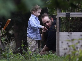 Joshua Boyle and his son Jonah play in the garden at his parents house in Smiths Falls, Ont., on Saturday, Oct. 14, 2017.
