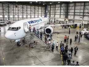 WestJet employees wait to board the new Boeing 737 MAX airplane.