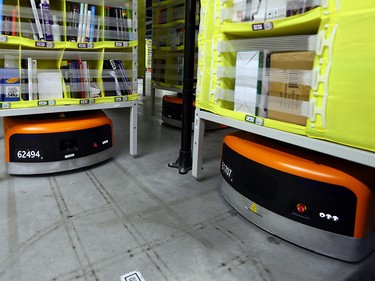 Robots move packages for distribution inside the Amazon fulfillment centre in Brampton, Ont.
