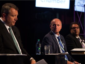 Mayoral Candidate Andre Chabot (c) listens to fellow candidate Bill Smith (l) answer a question during a municipal election townhall with local Calgary business leaders and owners at The Palace in downtown Calgary Monday October 2nd, 2017 Andy Nichols / Postmedia

Postmedia Calgary
Andy Nichols, Andy Nichols/Postmedia