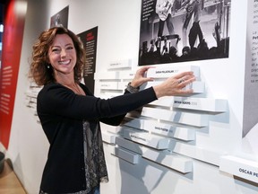 Sarah McLachlan places her plaque on the wall at the National Music Centre in Calgary as part of her induction into Canadian Music Hall of Fame on Saturday.