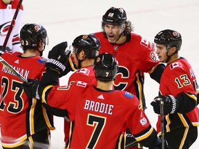 The Calgary Flames celebrate Sean Monahan's goal assisted by Jaromir Jagr and Johnny Gaudreau during the third period of NHL action against the Carolina Hurricanes at the Scotiabank Saddledome in Calgary on Thursday October 19, 2017.