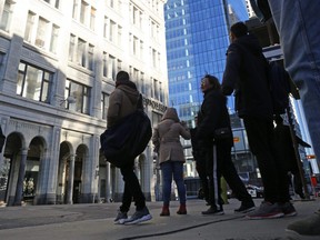 Pedestrians are diverted while the Calgary fire department dealt with panes of glass which fell from a downtown tower onto 1 street S.W. between 6th and 7th avenues on a windy Sunday morning October 29, 2017. Gavin Young/Postmedia