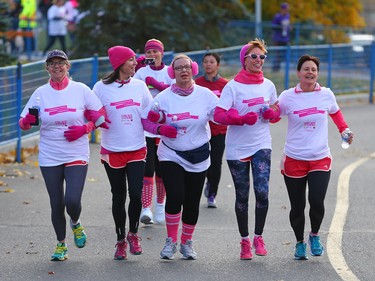 CIBC Run for the Cure participants link arms as they reach the finish line in this year's event at South Centre in Calgary on October 1, 2017. Over 5000 took part in this year's run.