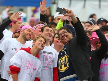 Calgary Mayor Naheed Nenshi sets up a selfie with participants at the start line of the CIBC Run for the Cure at South Centre in Calgary on October 1, 2017. Over 5000 took part in this year's run.