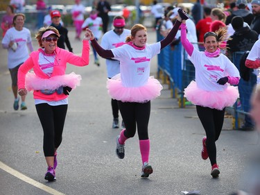 CIBC Run for the Cure participants join hands as they reach the finish line in this year's event at South Centre in Calgary on October 1, 2017. Over 5000 took part in this year's run.