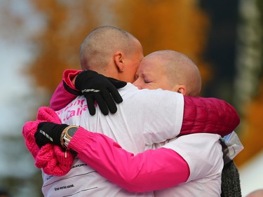 Calgary Running Room staff hug after having their heads shaved as a fundraiser at the start of this year's CIBC Run for the Cure at South Centre in Calgary on October 1, 2017. Over 5000 took part in this year's run.