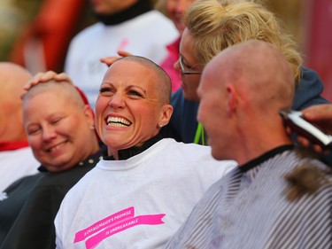Shara Hoyem smiles with other Calgary Running Room staff after having their heads shaved as a fundraiser at the start of this year's CIBC Run for the Cure at South Centre in Calgary on October 1, 2017. Over 5000 took part in this year's run.