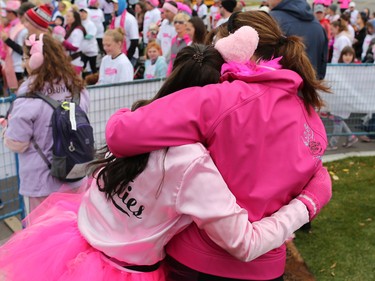 CIBC Run for the Cure participants hug as runners cross the start in the event at South Centre in Calgary on October 1, 2017. Over 5000 took part in this year's run.