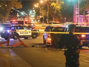 Police investigate the scene where a car crashed into a roadblock in Edmonton Alta, on Saturday, Sept. 30, 2017.  Police say a vehicle rammed a traffic control barricade and sent an officer flying into the air 15 feet. (Jason Franson/The Canadian Press via AP) ORG XMIT: EDM703
Jason Franson, AP