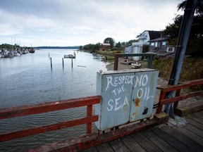 Graffiti reading "Respect The Sea, No Oil" is seen on a bridge in Massett, British Columbia, Canada, on Thursday, Aug. 25, 2016.