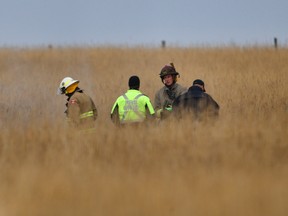 Emergency crews at the scene of a small plane crash near Springbank airport on Thursday, Oct. 28, 2017.