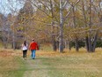 A couple walks through a park — formerly Highland Golf Course — in Ward 4 in northwest Calgary.