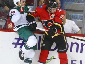 Flames Sean Monahan (R) collides with Wild Jared Spurgeon during third period NHL action between Minnesota Wild and the Calgary Flames in Calgary Saturday, October 21, 2017. Jim Wells/Postmedia