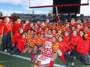Members of the Calgary Dinos Women's Rugby team celebrate in Calgary on  Sunday, October 22, 2017 after defeating the Victoria Vikes 26-21 in the Canada West final. Jim Wells/Postmedia
