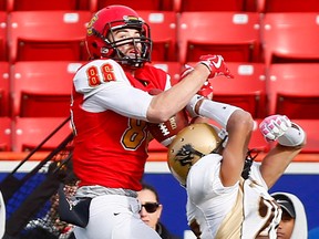 Calgary Dinos weapon Hunter Karl goes up for the catch with Manitoba Bisons Shelley Arja on him during Game action at McMahon stadium in Calgary on Saturday, October 14, 2017.