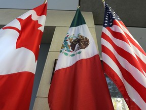 Mexican, U.S. and Canadian flags sit in the lobby during NAFTA negotiations in Ottawa on Sept. 24, 2017.