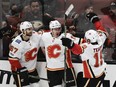 Members of the Calgary Flames celebrate center Mikael Backlund's (11) goal against the Anaheim Ducks onMonday, Oct. 9, 2017.