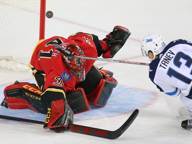 Winnipeg Jets  Brandon Tanev scores on goaltender Mike Smith of the Calgary Flames during NHL hockey at the Scotiabank Saddledome in Calgary on Saturday, October 7, 2017. Al Charest/Postmedia