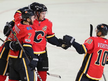 Calgary Flames TJ Brodie celebrates with teammates Johnny Gaudreau and Sean Monahan after scoring against the Winnipeg Jets in NHL hockey at the Scotiabank Saddledome in Calgary on Saturday, October 7, 2017. Al Charest/Postmedia