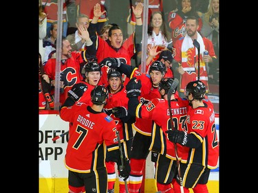 Calgary Flames Johnny Gaudreau celebrates with teammates after scoring against the Winnipeg Jets in NHL hockey at the Scotiabank Saddledome in Calgary on Saturday, October 7, 2017. Al Charest/Postmedia