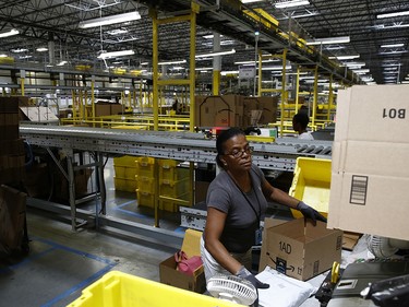 Myrtice Harris packages products for shipment at an Amazon fulfillment centre in Baltimore.