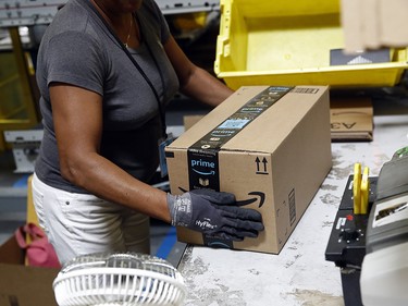 Myrtice Harris applies tape to a package before shipment at an Amazon fulfillment centre in Baltimore.