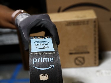 Myrtice Harris displays Amazon Prime shipping tape as she packages products at an Amazon fulfillment centre in Baltimore.