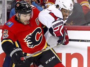 Flames captain Mark Giordano battles Washington Capitals Devante Smith-Pelly in first period action at the Scotiabank Saddledome in Calgary on Sunday, Oct. 29, 2017.