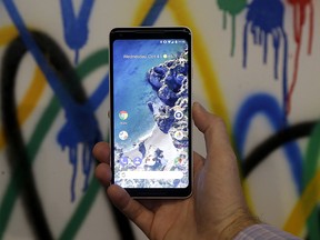 A Google employee holds up a Google Pixel 2 XL phone at a Google event at the SFJAZZ Center in San Francisco on Oct. 4, 2017.