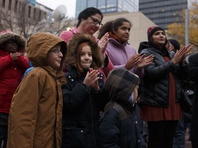 Edmontonians take in speeches during the Stand Together Against Violence in Solidarity with EPS vigil organized by Alberta Muslim Public Affairs Council at Churchill Square in Edmonton, Alberta after a police officer and four bystanders were injured in a terrorist attack on Sunday, October 1, 2017.