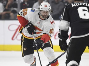 Calgary Flames right wing Jaromir Jagr, left, of the Czech Republic, moves the puck as Los Angeles Kings defenseman Jake Muzzin defends during the third period of an NHL hockey game, Wednesday, Oct. 11, 2017, in Los Angeles. The Flames won 4-3 in overtime. (AP Photo/Mark J. Terrill) ORG XMIT: LAS112