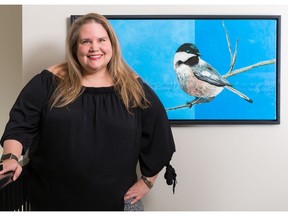 Marnie Joy Erickson with her art displayed in a Baywest Homes show home in Cranston's Riverstone.