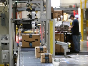 In this Aug. 3, 2017, photo, packages pass through a scanner at an Amazon fulfillment center in Baltimore.