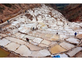 Visitors clamber between the ancient salt pans of Maras, jointly owned by two communities who still mine quality salt for a living. The surreal, multi-coloured pans almost look like ice. Photo, Theresa Storm