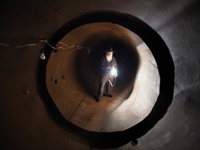 Bruce Beach walks through an exit of the Ark Two bomb shelter.