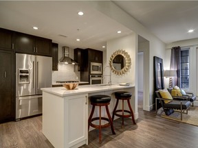 The kitchen, with full-size appliances and a full-height glass tile backsplash in the E floor plan at Riviera on the Bow, by DaVinci Homes.