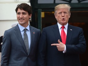 U.S. President Donald Trump points to Prime Minister Justin Trudeau as he welcomes him to the White House in Washington, D.C. on Wednesday, Oct. 11, 2017.