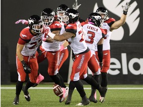 The Calgary Stampeders celebrate after teammate William Langlais (23) recovered a blocked punt for the touchdown during first half CFL football action against the Hamilton Tiger-Cats, in Hamilton, Ont., on Friday, October 13, 2017.