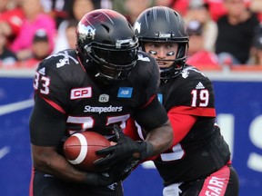Stamps RB Jerome Messam takes a hand-off from QB Bo Levi Mitchell.