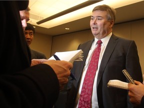 Steve Reynish, executive vice-president of Suncor, speaks  to reporters after the votes were counted approving the sales of the final Canadian Oil Sands shares to Suncor Monday March 21, 2016 at Calgary's Telus Convention Centre. (Ted Rhodes/Postmedia)