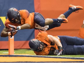 Dontae Strickland #4 of the Syracuse Orange dives into the endzone for a touchdown during the first quarter against the Clemson Tigers at the Carrier Dome on October 13, 2017 in Syracuse, New York.