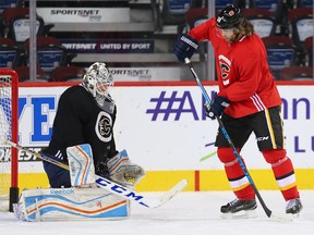 Calgary goaltender Todd Ford blocks a shot in front of Jaromir Jagr during practise with the Calgary Flames in Calgary on Thursday October 5, 2017. Ford is a Calgary firefighter who was filing in for the day and it was Jagr's first practice with the Flames.