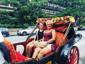 Kelly Bemmes, left, and her mom, Kimberly Bemmes, enjoy a horse and carriage ride during a surprise vacation in Philadelphia.