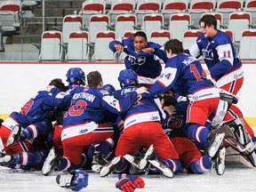 Team BC celebrates their gold-medal goal after Ben King tipped in Ryan Watson’s point shot at 2:37 of OT. Photo courtesy Derek Leung/WHL.
