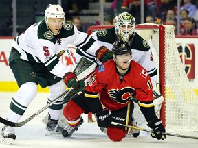 Flames Matthew Tkachuk takes a beating in front of Wild goaltender Devin Dubnyk during a game last season.
